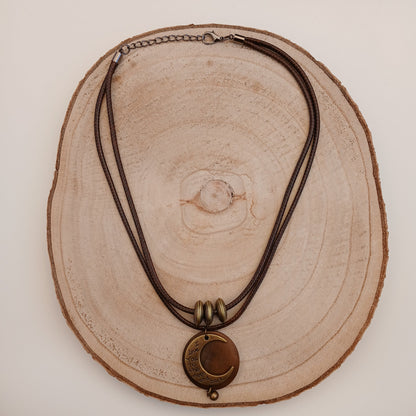 Necklace with a pendant on a wooden surface